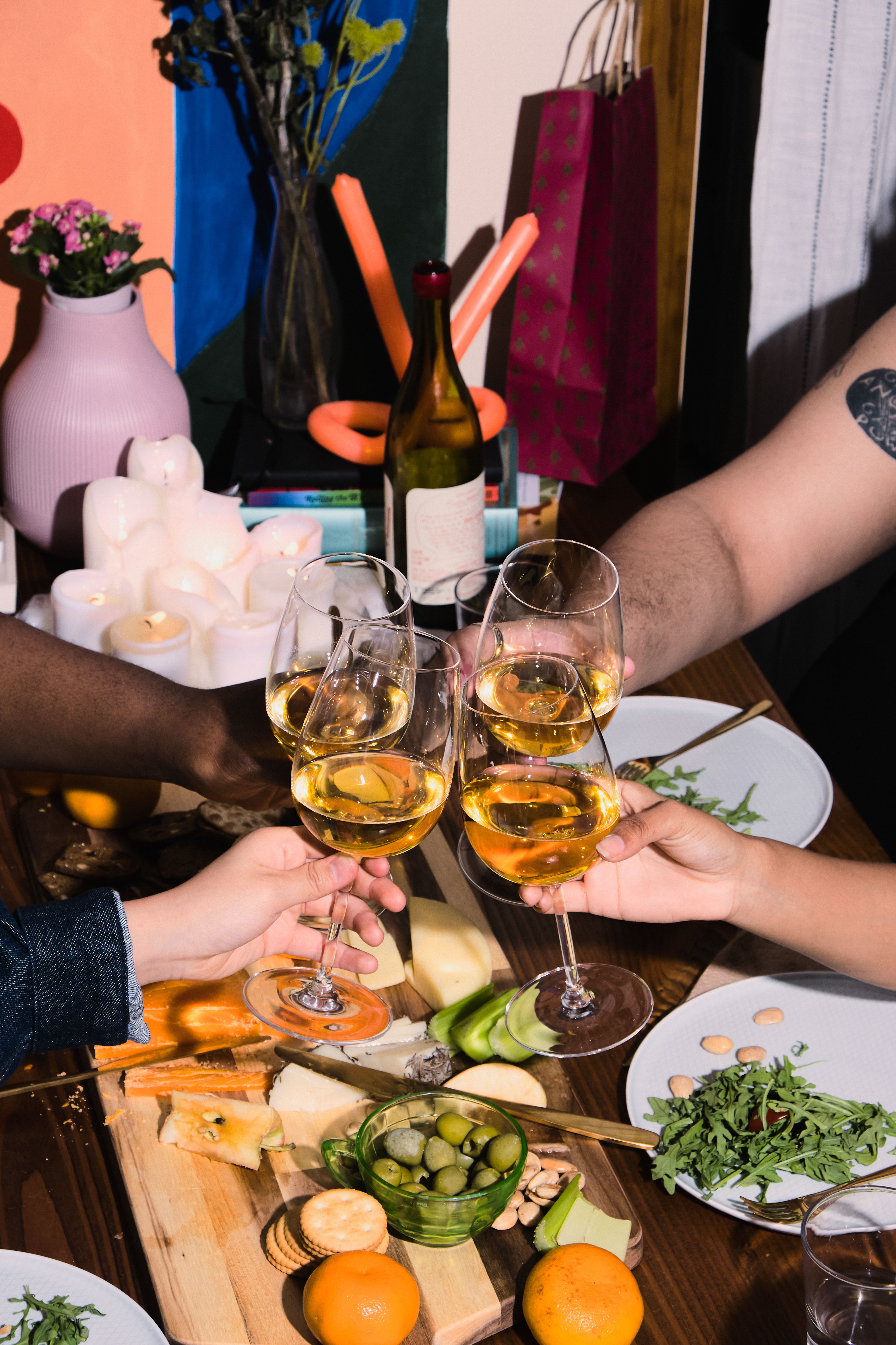 A group of friends of varying genders celebrating at a dinner party